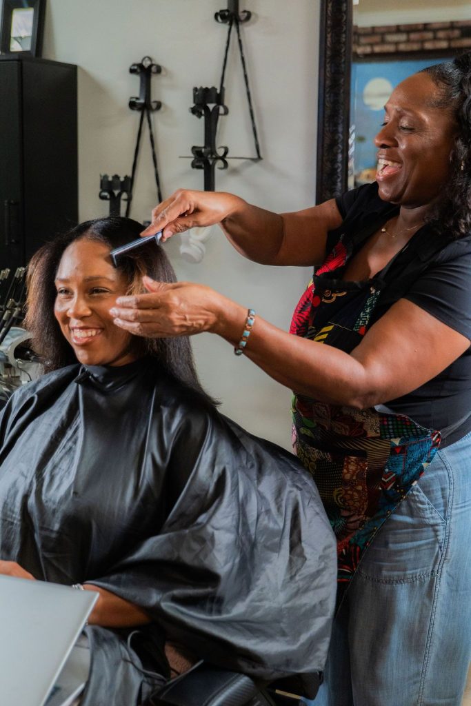 Client receiving a custom haircut and styling at Realities Phase II Salon